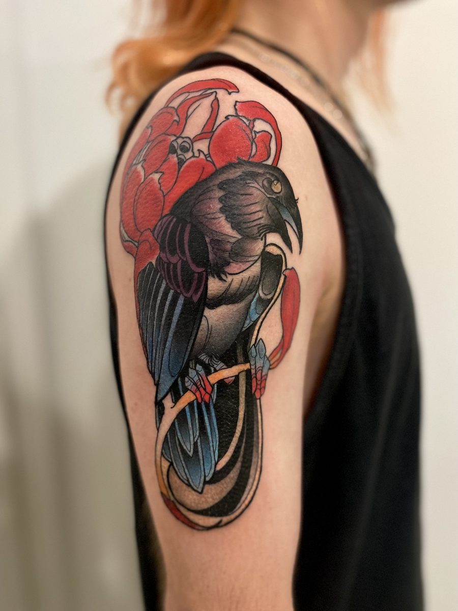 Neo-traditional magpie tattoo with red florals by Sunshine Coast tattoo artist Jase